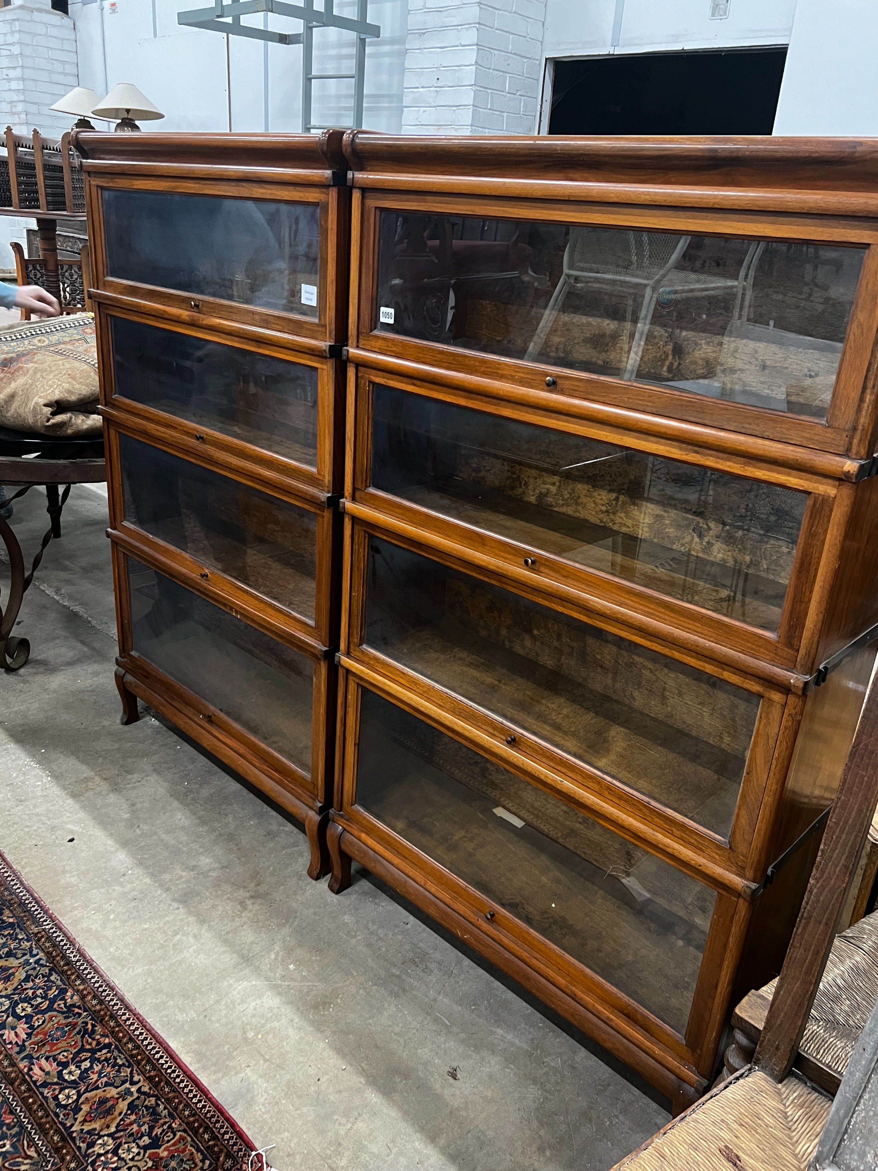 A pair of Globe Wernicke four section walnut bookcases, length 87cm, depth 31cm, height 147cm